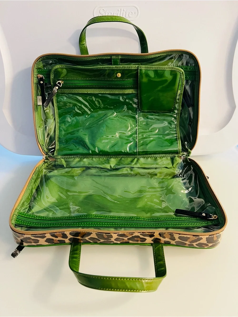 Brand new. Large Kate Spade cosmetic bag. Leopard print with green lining/trim.